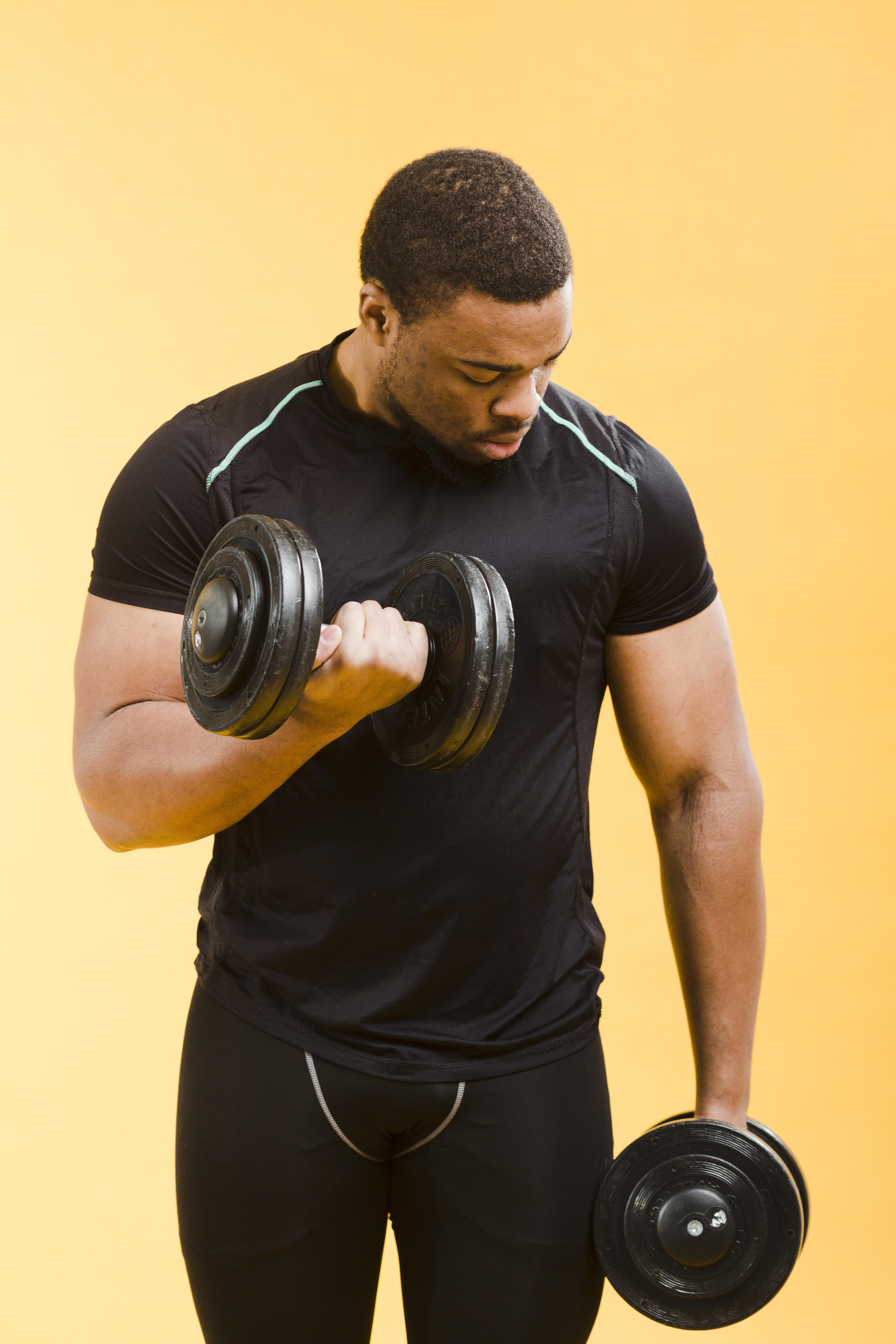 Standing dumbbell biceps curl with supination